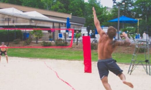 man serving during beach volleyball game