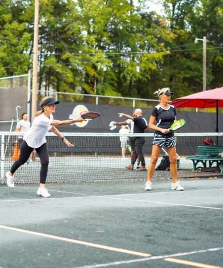 group of people playing pickleball