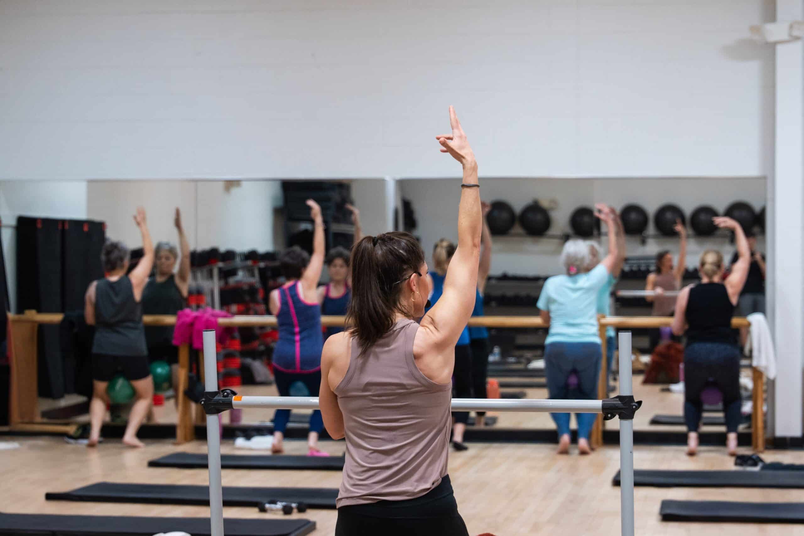Group yoga class with participants stretching.